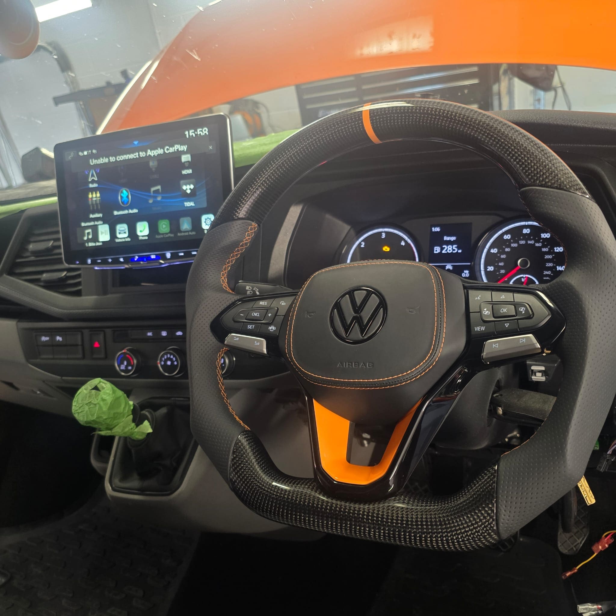 Handmade UK carbon fibre steering wheel retrofit with orange stitching
